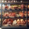 Variety of sausages displayed in a well-lit, modern deli case, showcasing an assortment of flavors and sizes.