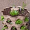 A variety of small starter herbs and vegetables are planted vertically on an apartment patio garden