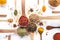 Variety of spices and herbs in spoons and bowls on white background. Top view. Cooking ingredients and condiments concept