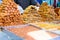 Variety of sweets on the arab street market stall. Eastern sweets in a wide range, baklava, Turkish delight with almond, cashew an