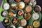 Variety of tasty Asian dishes top view packed on leaf background