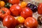 Variety of tasty ripe french tomatoes in wooden boxes on farmers market in Provence in summer