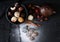 A variety of truffles in a black clay pile, walnut kernels and p