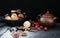 A variety of truffles in a black clay pile, walnut kernels and p