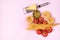 Variety of Types and Shapes of Dry Pasta Spaghetti Tagliatelle Fusilli Raw Tomatoes Bowl of Pesto Parmesan Cheese Top View Pink