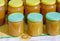 A variety of varieties of honey in jars offered for sale at the