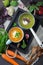 Variety of vegetarian soups cream of carrot and broccoli cabbage on a dark concrete background. Selective focus. Top view. Copy