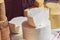 A variety of wheels of cheese seasoned with herbs for sale at the deli counter in the supermarket