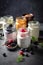 Variety of yogurts in portion glass jars. Healthy summer breakfast concept AI generated