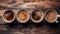 Various aromatic coffee mugs arranged in a delightful overhead view on a rustic wooden table