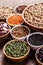 Various assortment set of indian legumes in bowls on wooden background