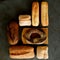 Various baked bread on black background, knolling style. Baking products.