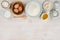 Various bakery ingredients on wood textured table, view from above