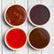 Various barbecue sauces in ceramic bowls