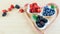 Various berries in the bowls and dosing tape on the wooden table. Healthy eating, balanced fruit diet, proper nutrition concept