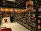 Various bottled drinks neatly arranged on a shelf inside the mall,