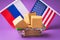 Various boxes in a food basket and flags of Russia and America on a colored background