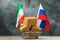 Various boxes in a food basket and two flags on an abstract background, the concept of trade between Iran and Russia