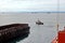 Various bulk carriers, vessels, and tugboats in port under cargo operations and underway. Port of Muara Pantai, Indonesia, January