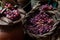 Various bunches of red grapes on wicker basket