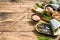 Various canned fish and seafood in a metal cans. Wooden background. Top view. Copy space