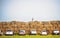 Various Cars Parked By the Stack Hay High Wall in Countryside. Agricultural Farming or Building the Wall, Barrier Concept
