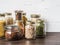 Various cereals and seeds - peas split, beans, rice, pasta, oatmeal, flax, lentils, bulgur in glass jars on the table in the