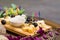 Various cheese on wooden board with grapes and honey