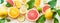 Various citrus fruits background banner with halves, slices and green leaves. Top view. Vitamin C. Healthy natural immun boosters