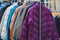 Various collection winter coats hanged on a clothes rack