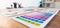 Various color palette idea papers arranged on workspace for designer. Scrutinize