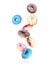 Various colored donuts in the air on a white background