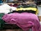 Various colored sheep skins on table