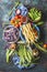 Various colorful beans and peas in bowls on rustic background