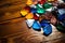 various colorful guitar picks scattered on a wooden table