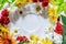 Various colorful spring flowers creating pattern on white saucer background. Flat lay summer natural concept.