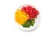 various colors of cutted pieces of organic peppers in a white plate on white background on top view