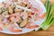 Various cooked seafoods on white dish, fragment close-up