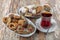 Various cookies and candies served on the table next to the tea. Assorted cookies and coffee, afternoon tea arrangement