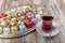 Various cookies and candies served on the table next to the tea. Assorted cookies and coffee, afternoon tea arrangement