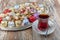 Various cookies and candies served on the table next to the tea. Assorted cookies and coffee, afternoon tea arrangement