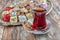 Various cookies and candies served on the table next to the tea. Assorted cookies and coffee, afternoon tea arrangement