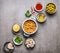 Various cooking ingredients in bowls for Chickpea salad on gray concrete background, top view