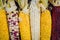 Various corn cobs on dark background top view