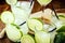 Various cups and doses of caipirinha, typical Brazilian drinks, of lemon, with cachaÃ§a and sugar, on rustic wooden background,