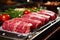 Various cuts of fresh raw red meat in the supermarket, beef, pork, assorted meat steaks