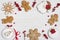 Various decorated gingerbread cookies and holly berries on wooden background