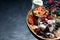 various desserts with berries and cream on dark background