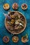 Various Dried healing herbs and flowers on a blue background