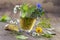 Various dried meadow herbs and herbal tea on old wooden table. fresh medicinal plants and in bundle. Preparing medicinal